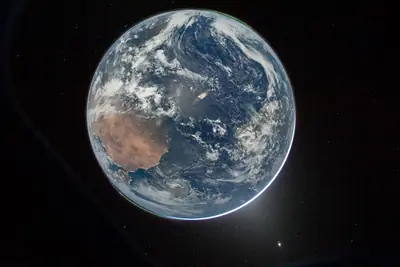 Artemis II photo ART002-E-192: Hello, world.” Earth upside-down: northern Africa, Spain, the Atlantic and two green auroras