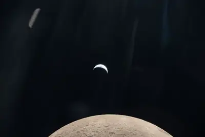 Artemis II photo ART002-E-19210: Earthset at 22:31 UTC: Earth sinking behind the Moon