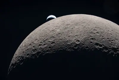 Artemis II photo ART002-E-21208: Earthset — Earth dropping behind the lunar horizon