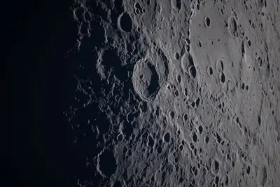 Artemis II photo ART002-E-21357: Earthset at 22:57 UTC: Earth sinking behind the Moon