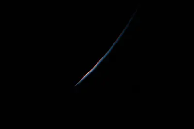 Artemis II photo ART002-E-23683: Earth falling away after the translunar burn, 13,425 km out