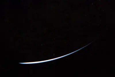 Artemis II photo ART002-E-23699: Earth falling away after the translunar burn, 14,364 km out