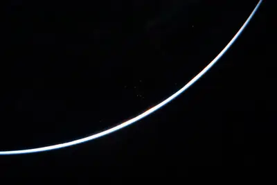 Artemis II photo ART002-E-23702: Earth falling away after the translunar burn, 14,519 km out