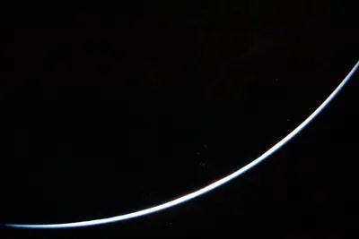 Artemis II photo ART002-E-23705: A sliver of sunlit Earth, minutes after the burn that sent Orion to the Moon