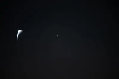 Artemis II photo ART002-E-24904: Earthset at 23:21 UTC: Earth sinking behind the Moon