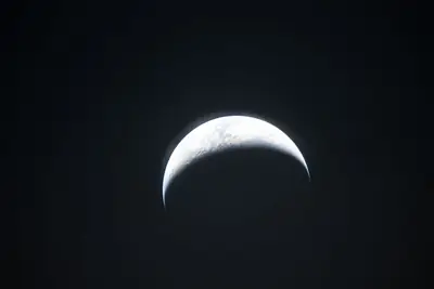 Artemis II photo ART002-E-25088: Earthset at 23:23 UTC: Earth sinking behind the Moon
