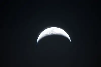 Artemis II photo ART002-E-25137: Earthset at 23:23 UTC: Earth sinking behind the Moon