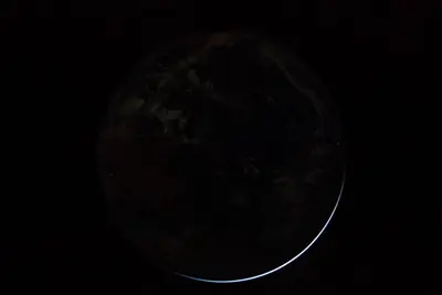 Artemis II photo ART002-E-25484: Earth falling away after the translunar burn, 15,862 km out